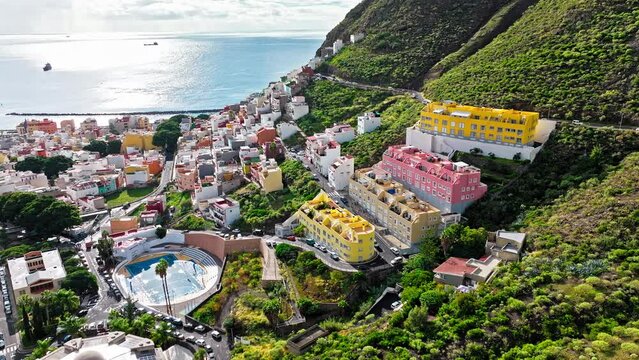 Aerial view of a posh tourist resort with traditional Spanish houses with large windows in Tenerife, Spain. View from above of colourful houses and hotels in San Andr&eacute;s, Canary Islands. 