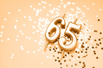 65 years celebration festive background made with golden candles in the form of number Sixty-five...