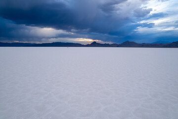 Aerial of Utah Bonneville Salt Flats with cloudy skies.  Shot on a drone.  Blue cracked salt flat near Salt Lake City, Utah in the western part of the United States.