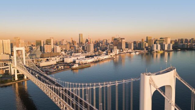 tokyo city cityscape aerial view drone of rainbow bridge shot at sunrise dawn,modern town waterfront with skyscrapers in the background