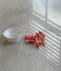 pills lumped together on white desk adderall 30mg addiction bottle in home office