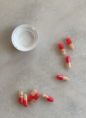 portrait of pills spread out on white desk adderall 30mg addiction bottle in home office