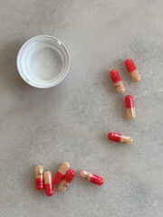 pills spread out on white desk adderall 30mg addiction closeup 