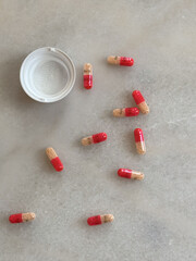 pills spread out on white desk home office adderall 30mg addiction  