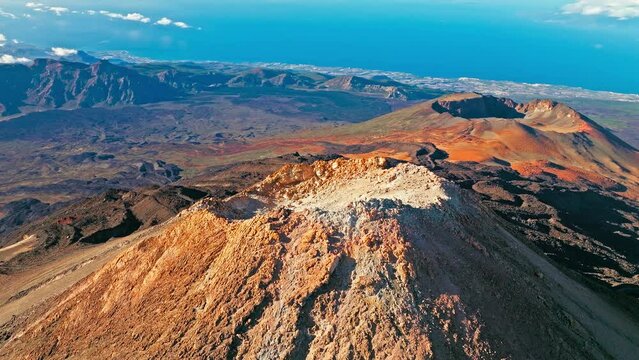 Aerial view of Mount Teide active volcano in Tenerife, Canary Islands. View from above the highest peak mountain with a scenic aerial cable car and hiking trails in Tenerife, Spain.