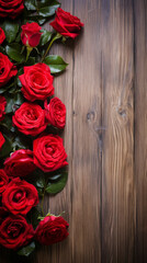 Wooden table background with red roses frame. Valentines day advertisement concept. Space for text