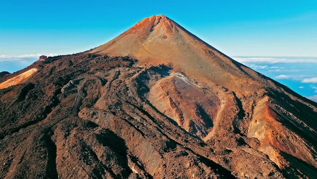 Aerial view of Mount Teide active volcano in Tenerife, Canary Islands. View from above the highest peak mountain with a scenic aerial cable car and hiking trails in Tenerife, Spain.