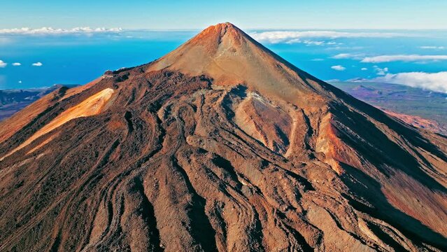 Aerial view of Mount Teide active volcano in Tenerife, Canary Islands. View from above the highest peak mountain with a scenic aerial cable car and hiking trails in Tenerife, Spain.