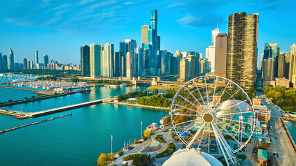 Naklejka premium Tourism coast aerial Navy Pier Centennial Wheel sunrise with skyscrapers in Chicago, Lake Michigan