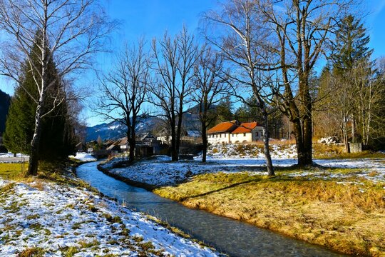 Jezernica stream flowing past Zgornje Jezersko village in winter in Gorenjska, Slovenia