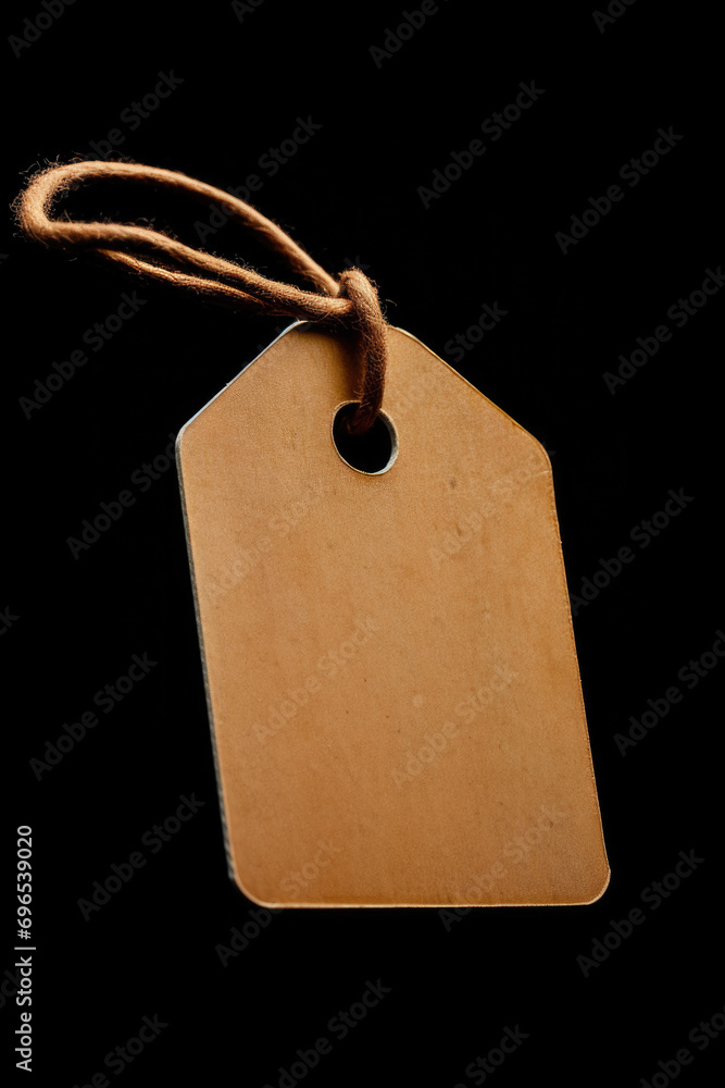 Poster Brown tag with string on a black background. Can be used for labeling or tagging items.