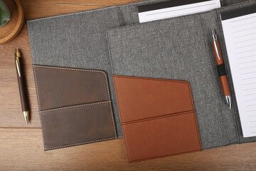 Leather and fabric flap portfolio. Concept shot, top view, flap portfolio in different colors and leather pen. Custom background flap portfolio view. Flap portfolio and accessories.