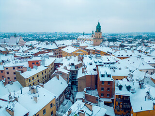 white snowy winter at European old town Lublin, snow storm and snowfall over roof at ancient Poland, Europe aerial