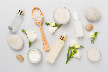Flat lay with spa products and flowers on color background