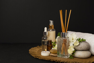 Spa composition with freesia flower and aroma diffuser on concrete background