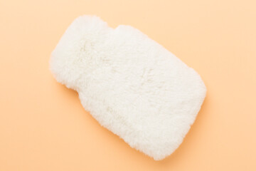 Fluffy water warmer bag on color background