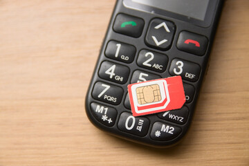 Prepaid card and old mobile phone with large keys for elderly users who do not use smartphones