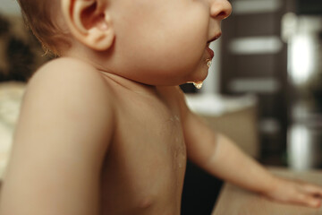 Close-up of saliva on baby's lower face