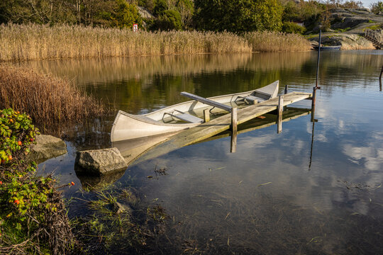 Sunken aluminium canoe in shallow water.