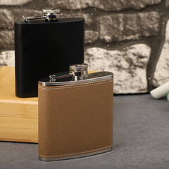 Diffirent colors stainless flask. Concept shot, top view. Custom background flask view. Flask and accessories.