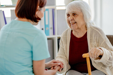 Nurse Assists Elderly Woman In Doctor'S Office
