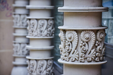 White columns with seashell pattern in shape of number two repeated around pillar, background asset