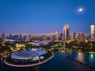 Shedd Aquarium aerial Chicago with moon over city lights at night with harbor and Lake Michigan