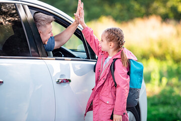 Dad Picks Up His Little Daughter From School In His Car And Gives Her A High Five