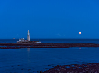 St Marys Island and lighthouse with moon and copy sace.