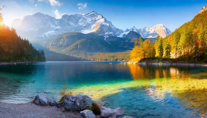 Fotobehang impressive summer sunrise on eibsee lake with zugspitze mountain range sunny outdoor scene in german alps bavaria germany europe beauty of nature concept background © Ashleigh