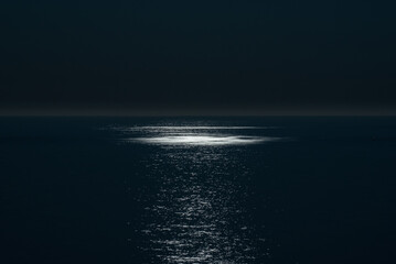 Reflection of full moon in the calm sea