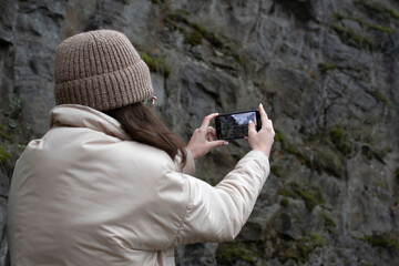 A young woman taking picture on a smartphone	