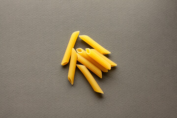 pasta in a wooden spoon on a dark background middle plan