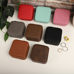 Diffirent colors leather jewelry box. Concept shot, top view. Custom background jewelry box view. Jewelry box and accessories.