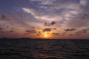 Naklejka na ściany i meble Ocean skyline. Cloudy sunset over the sea.