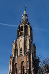 Fototapeta na wymiar Details of XV Nieuwe Kerk (New Church, 1396 - 1496) on Market square in Delft, Holland. New Church, with 108,5 m church tower - second highest church in The Netherlands. Delft.