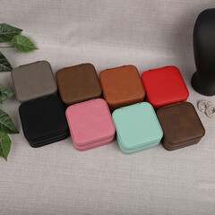 Diffirent colors leather jewelry box. Concept shot, top view. Custom background jewelry box view. Jewelry box and accessories.