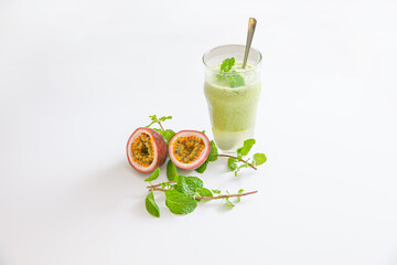 Vegetarian passion fruit and mint leaves smoothie in glass isolated on white background