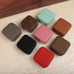 Diffirent colors leather jewelry box. Concept shot, top view. Custom background jewelry box view. Jewelry box and accessories.