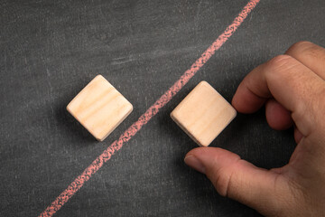 Competition and controversy concept. Wooden blocks on chalkboard background