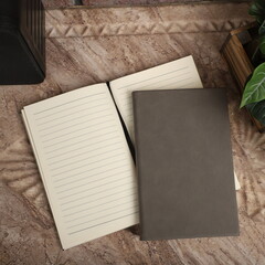 Leather Journals and Notebooks in gray colors. Concept shot, top view. Custom background Journals and Notebooks view. Leather Sketchbook. Space Blank for text