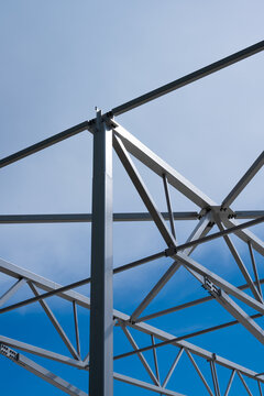 White painted steel beams and girders of a warehouse under construction.