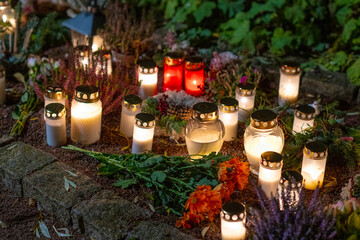 Grave candles on a cemetery on all saints eve.