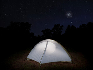 Christmas star shining bright over a small dome tent