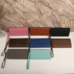 Women's leather wallets in different colors. Concept shot, top view. Custom background women's leather wallets view. Beautiful modern women's leather wallets