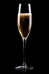 A crystal-clear flute glass of champagne isolated on black background