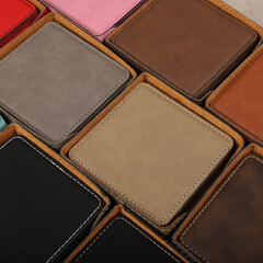 Leather table mats in different colors. Concept shot, top view. Custom background view of leather table coaster. Stitched and leather table coaster
