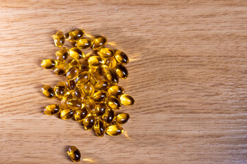 vitamin pills on wooden background. space for text