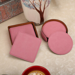 Leather table mats in pink colors. Concept shot, top view. Custom background view of leather table coaster. Stitched and leather table coaster