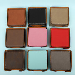 Leather table mats in different colors. Concept shot, top view. Custom background view of leather table coaster. Stitched and leather table coaster
